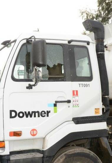 SMASHED: A broken window of one of the 13 trucks operated by Wodonga-based surfacing company Downer Edi Works. Police believe UHF radios were targeted. 