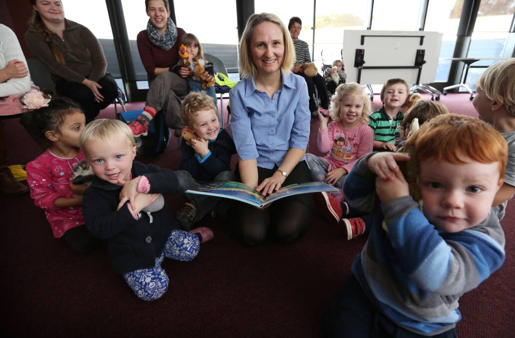GREENIES: Albury council sustainability officer Amber Rodd reads a story to a group of youngsters as part of 2014's World Environment Day activities.