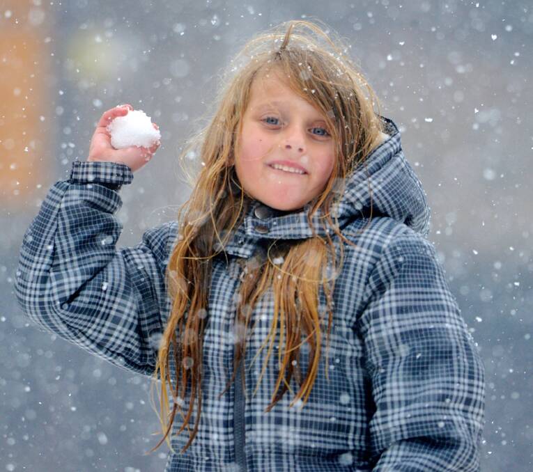 Fight time: Jacinta Jansen, 8, takes aim as some more flakes fall. Snow play was popular on Sunday.