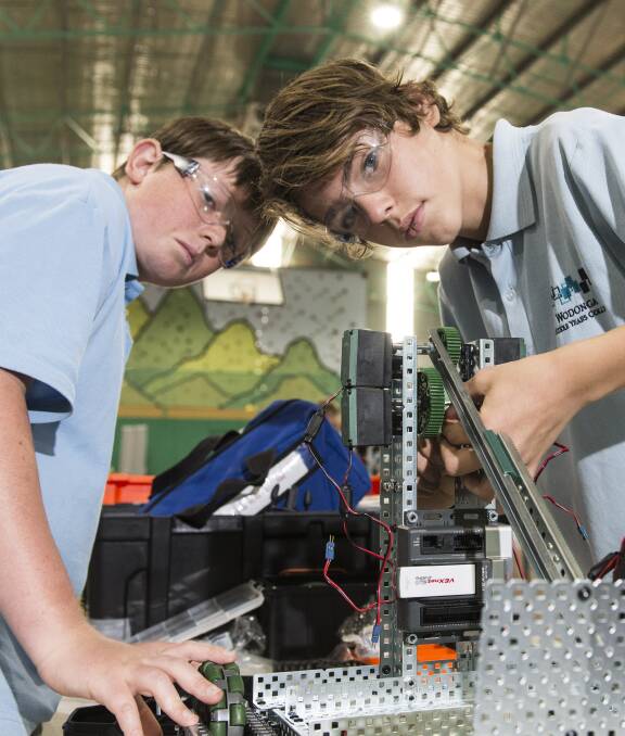 CYBORG: Wodonga Middle Years College students Jack Redcliffe and Jake Bell prepare their robot to compete at the national VEX Robotics championships on Saturday. 