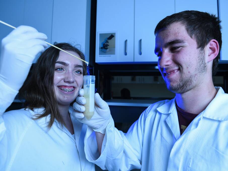 METHOD: James Fallon High School students Sam Hedrick, 15, and Jacob Miller, 17, extract DNA from wheat in an experiment. Picture: MARK JESSER