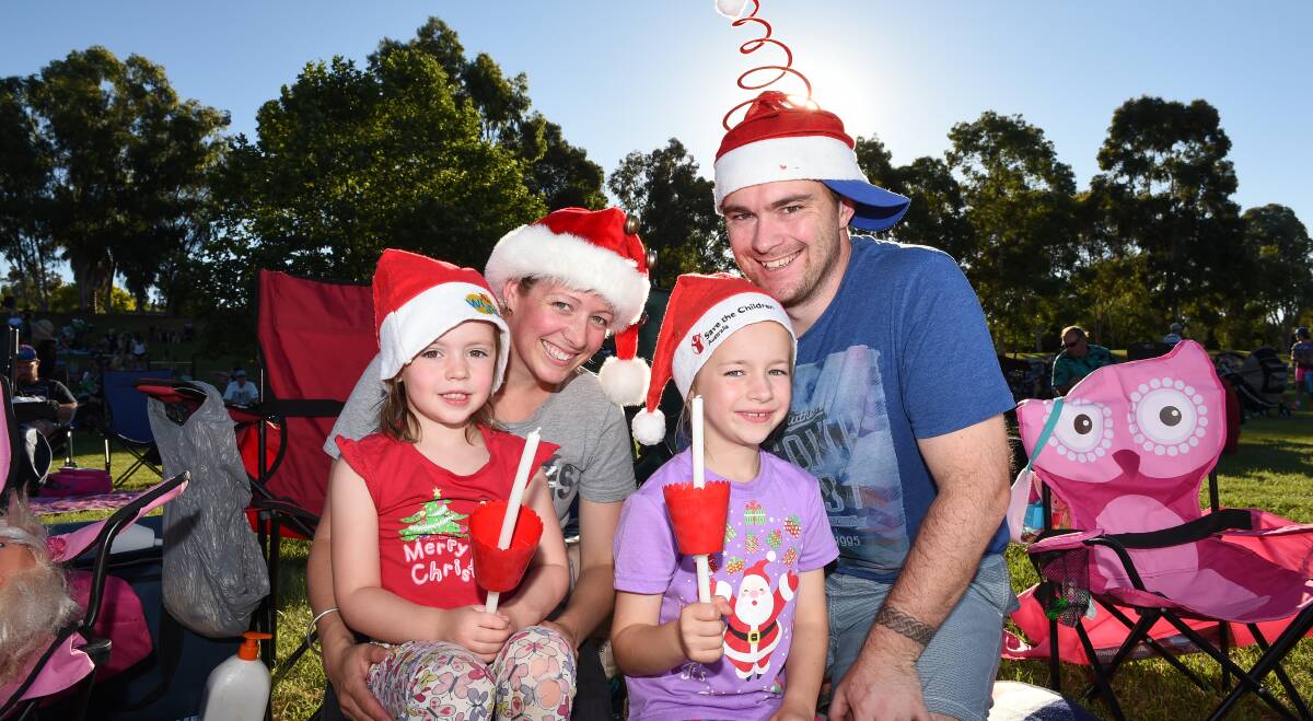 HAPPY CAMPERS: Elyse, 4, Jayde, Claire, 7, and David Bremner enjoy their first Carols by Candlelight in Wodonga on Sunday. Pictures: MARK JESSER