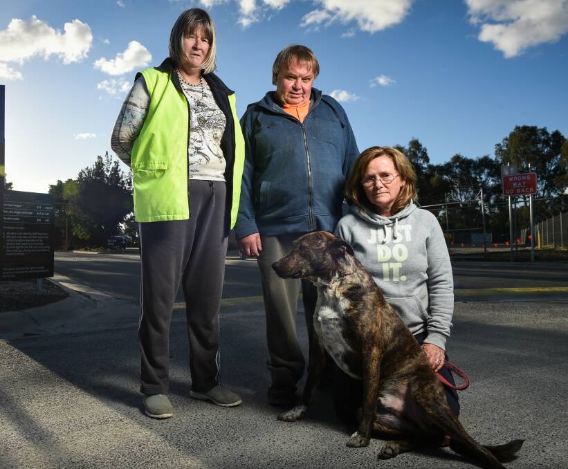 UNCERTAIN FUTURE: Wodonga Dog Rescue volunteers Shirley Giles, Wayne Higgins and president Peta McRae, with dog Jordi, prepare to say goodbye to their beloved pound for the last time. Photo: MARK JESSER