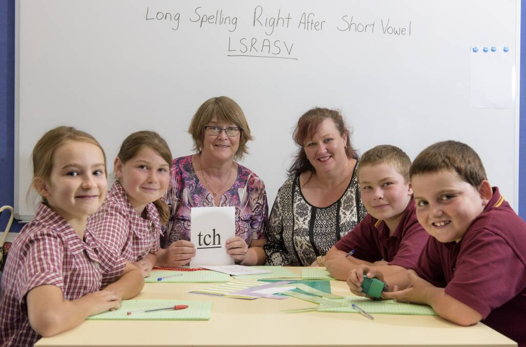 HELPING HAND: Lindy Wishart and Helen McConnell-Berndt (centre) with students Lilly Gueho, Claudia Nixon, Digby Howlett, and Brayden Creek. Picture: SIMON BAYLISS