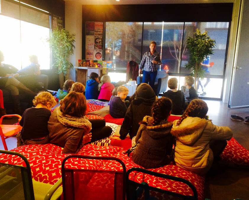 ENTHRALLED: Border children's author Susan Berran captivates her young audience during a school holiday workshop at the Retro Lane Cafe, Albury. Pictures: Supplied