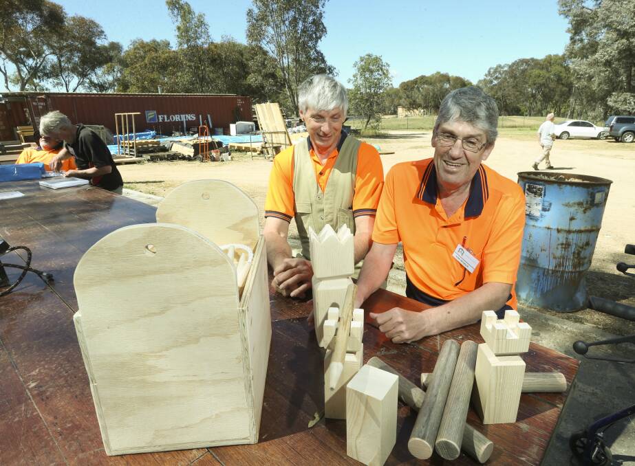 HELPING HANDS: Thurgoona Men's Shed stalwart Ray Tanner helped new member Adam Reynolds craft this wooden viking outdoor chess set. Sharing of knowledge is one of the cornerstones of the shed. PIcture: ELENOR TEDENBORG