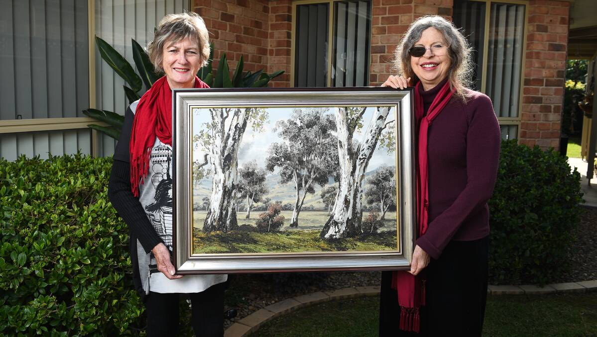 SUPPORT: Cecily McKenzie-McHarg with artist Joan Lehmann and the painting to be auctioned for a cancer centre fundraiser.  Picture: MARK JESSER