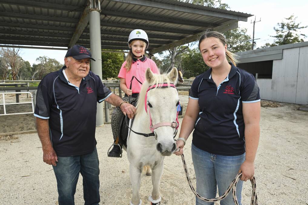 Albury's Riding for the Disabled Association president Carl Iverson with volunteer Jessie Knights, horse Tiki and rider Indigo, 8, ... the long-running charity is in desperate need of more quiet horses. Picture Mark Jesser