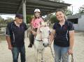 Albury's Riding for the Disabled Association president Carl Iverson with volunteer Jessie Knights, horse Tiki and rider Indigo, 8, ... the long-running charity is in desperate need of more quiet horses. Picture Mark Jesser
