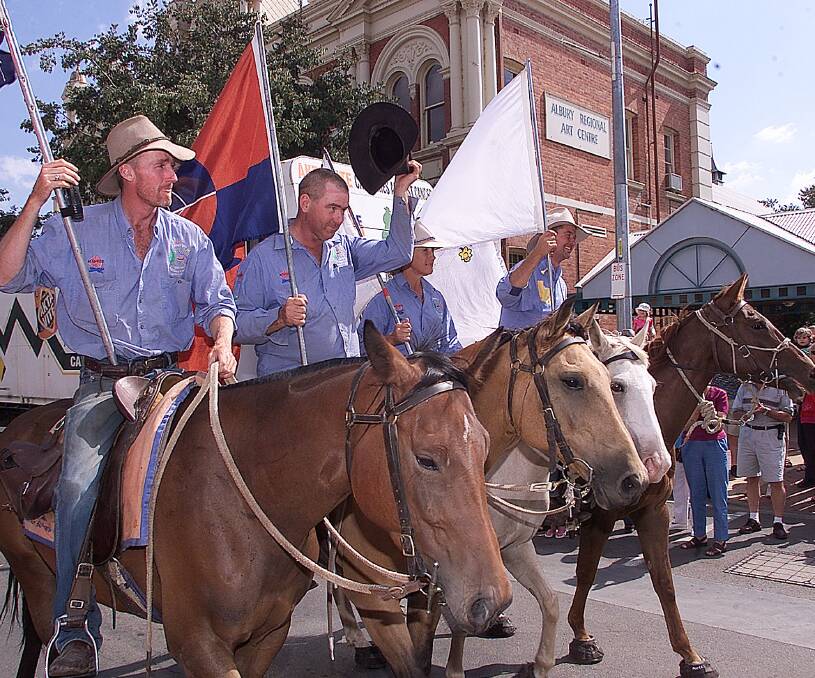 WELCOME HOME: Danny and his crew are given a warm reception along Albury's main street after their epic Campfires Against Cancer ride in 2002.