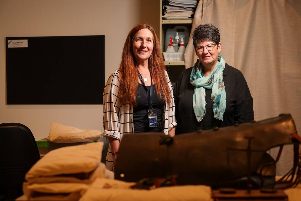 Indigo Shire Council visitor experience manager and precinct manager Jen Allan and Noeleen Lloyd in front of artefacts from the Burke Museum collection. Picture by James Wiltshire