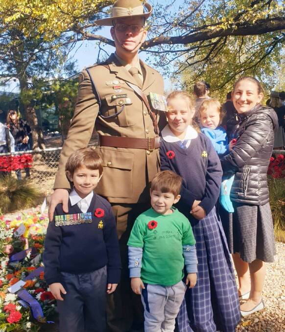 Jindera's Anzac Day guest speaker Captain Dominic Buchan with his family (bottom left to right) Robert, 7, Finn, 4, Cameron, 12 and wife Leonie holding Ricky, 1. Picture by Jodie O'Sullivan