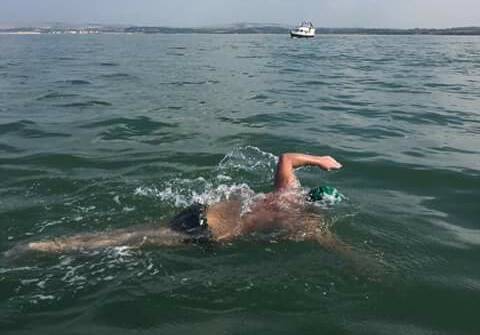 Channel champion: Rick Seirer crosses the "finish line" at the end of his swim across the English Channel this week, much to the delight of proud mum Elisabeth.