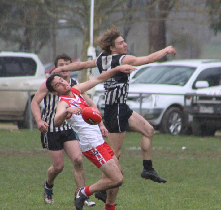 UNDER PRESSURE: Federal's Tom McKimmie and Magpie Isaac Warren do battle in the first semi-final. Picture: CORRYONG COURIER