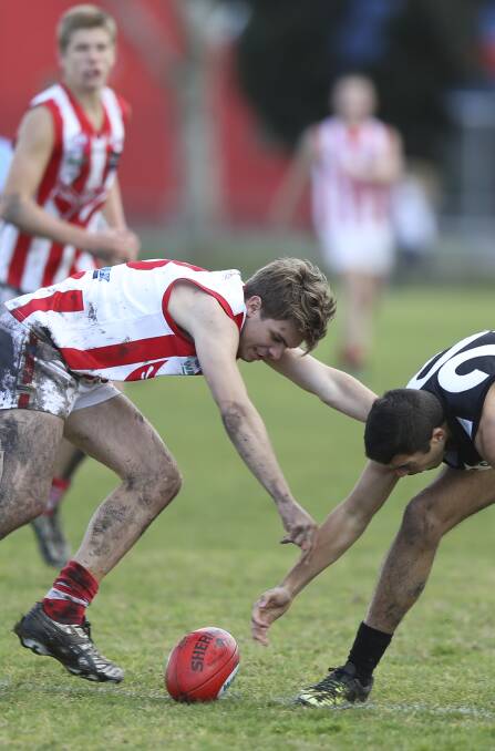 THE FIGHT IS ON: Henty's Andrew Yates and Magpie Dylan Hartin fight for possession on Saturday. Picture: ELENOR TEDENBORG
