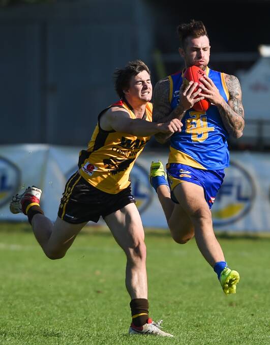 TAKING THE LEAD: Trent Castles marks in front of Hume defender Brian Lieschke during the first quarter.