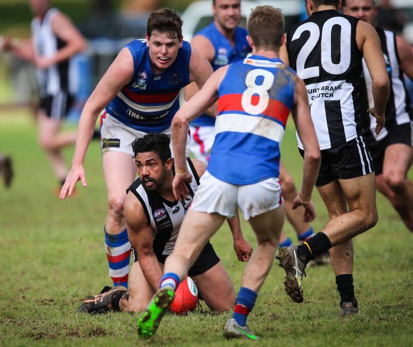 Magpie forward Matt Murray is swamped by the tight-knit Jindera defence during the preliminary final.