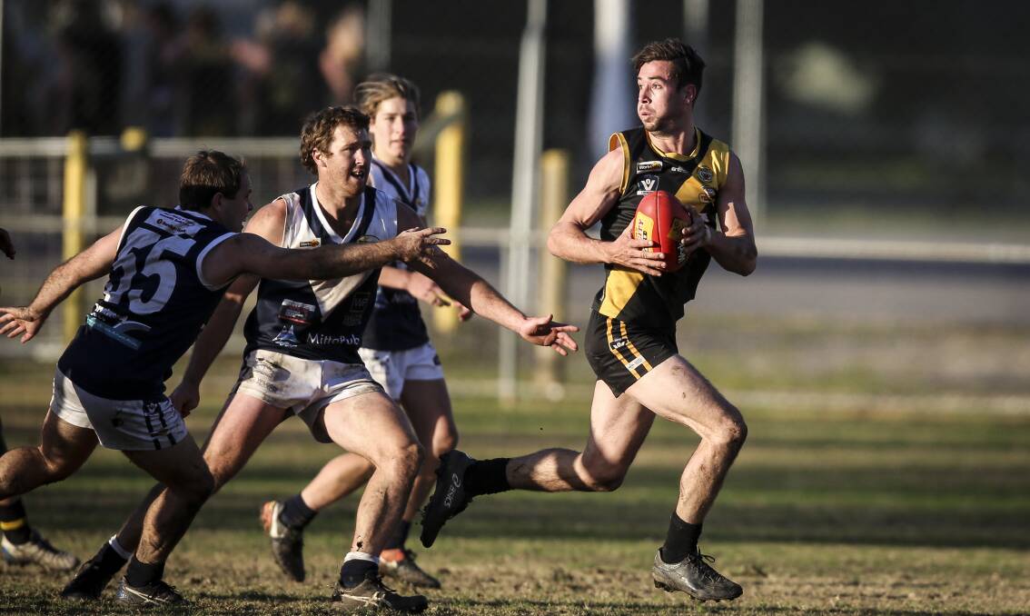 Tiger Josh Spence makes his way clear of traffic against Mitta United at Barnawartha.