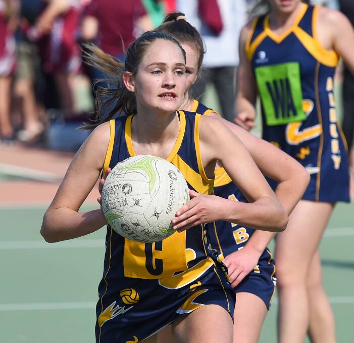 EAGLE-EYED: Promising Albury netballer Maggie St John prepares to off-load a pass in the open division at J.C. King Park on Sunday. Pictures: MARK JESSER