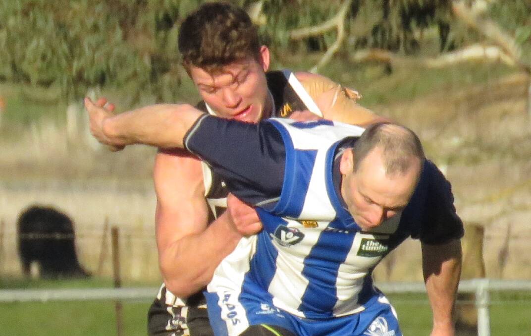 CAT AND MOUSE: Border-Walwa's Daniel McCarthy jostles for possession with Roo veteran Glenn Lavis at Tumbarumba on Saturday. Picture: WENDY LAVIS