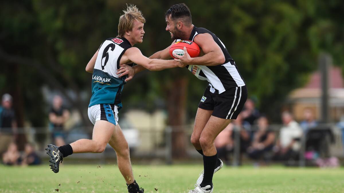 CDHBU's Ryan Mills attempts to tackle Magpie Damien Gray at Urana Road Oval.