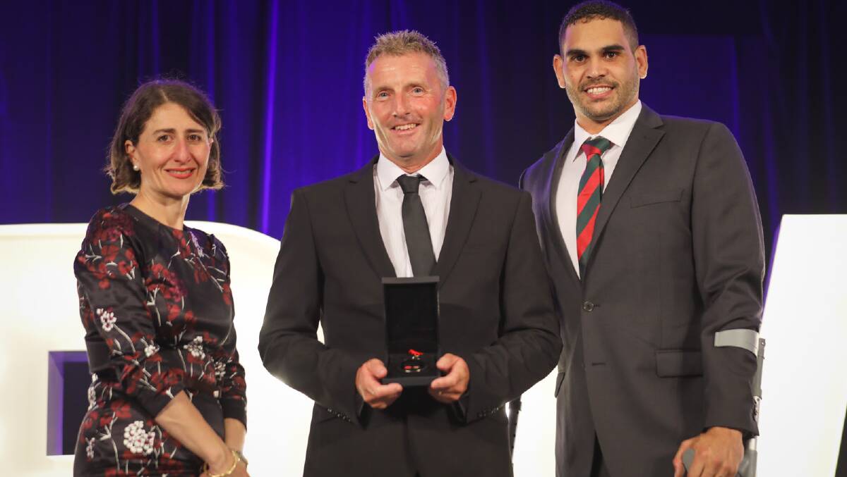 Premier Gladys Berejiklian and NRL star Greg Inglis congratluate Robbie Mackinlay on his award.