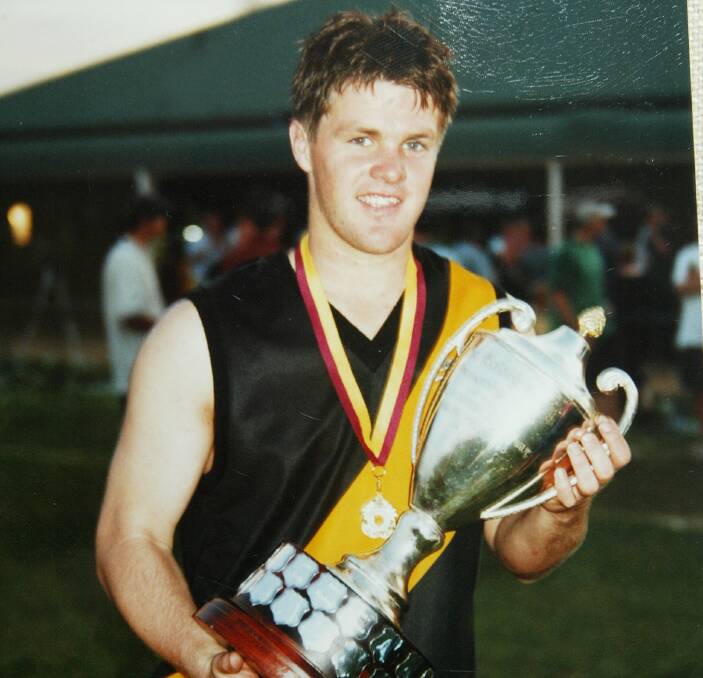 TURNING BACK THE CLOCK: Adam Schneider celebrates Osborne's 2001 grand final victory over Holbrook at Walbundrie. He will make a one-off appearance for his home club against Jindera on Saturday.