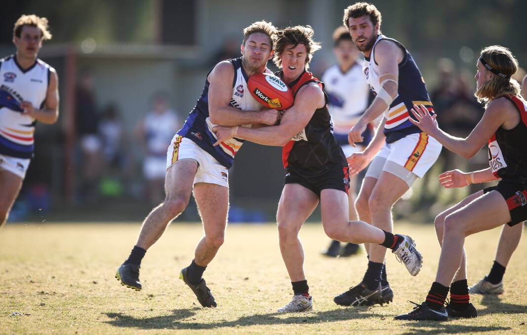 BANG: Crow Michael O'Riordan and Howlong's Tyson Logie refuse to give an inch during their Hume league clash at Howlong on Saturday. Pictures: JAMES WILTSHIRE
