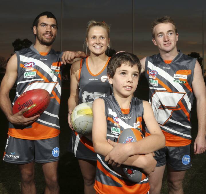 NEW LOOK: Jake Malay, Jess Kotzur, Ed Kreutzberger and Myall Hoffmann show off the Rand-Walbundrie-Walla Giants' new football and netball colours. Pictures: ELENOR TEDENBORG