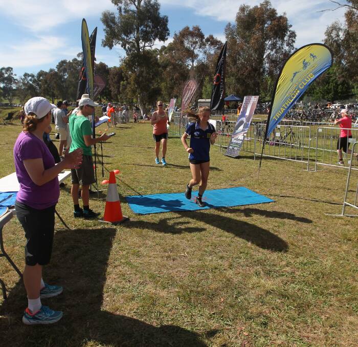 TOUGH TASK: Competitors cross the line in the Albury-Wodonga Triathlon Club's women's triathlon on Sunday. Picture: CHRIS YOUNG