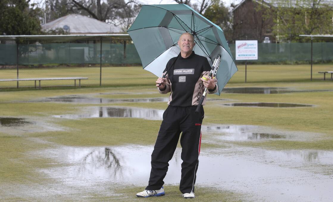 NO PLAY: Ken Wurtz looks over the saturated Albury Grasscourts. Matches will be played on hard courts on Saturday. Picture: ELENOR TEDENBORG