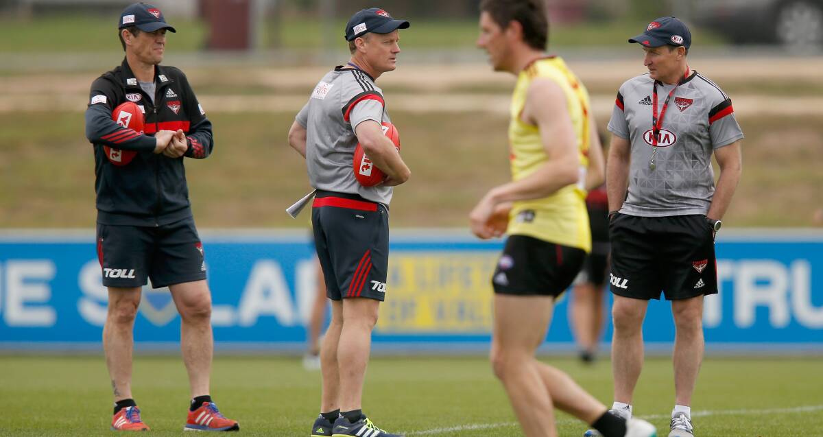 Bomber assistants Mark Harvey and Guy McKenna talk business with senior coach John Worsfold at training. Jason Akermanis hopes to join the AFL club's coaching staff.