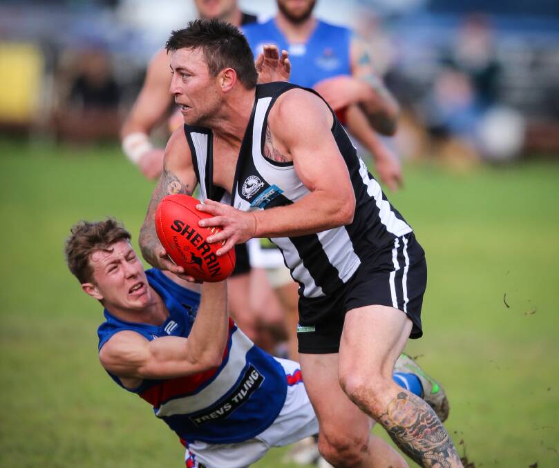 Magpie coach Josh Maher prepares to dish off a handball. Maher kicked one of his team's eight goals at Walbundrie.
