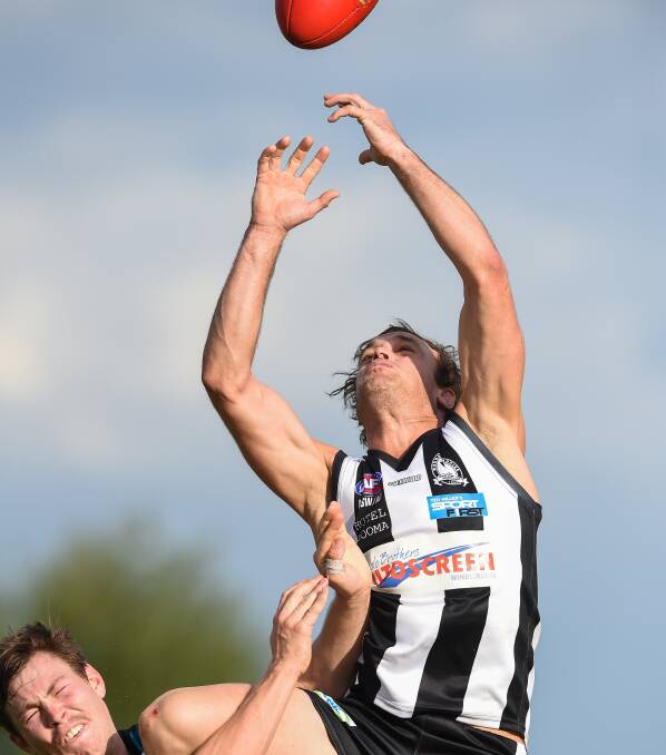 FLYING MAGPIE: Matthew Thorneycroft soars above Sam Haigh in their Hume league clash. The Murray Magpies won by 23 points. Pictures: MARK JESSER