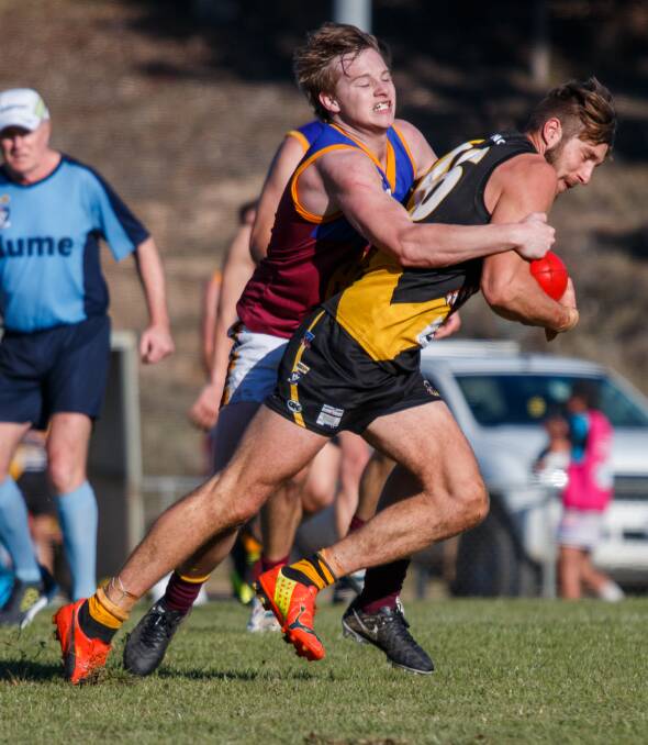 GOING NOWHERE: Whorouly's Brandon Bowen tackles Glenrowan's Max Scott in the Ovens and King league on Saturday. The Tigers won the clash at Glenrowan by 44 points. Pictures: WANGARATTA CHRONICLE
