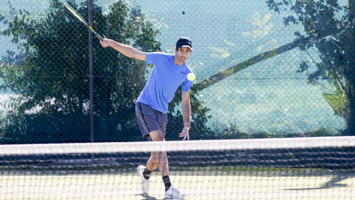 WHACK: Albury's Pat Landy thunders a backhand during the Albury Easter Tennis Tournament on Saturday. Pictures: SIMON BAYLISS