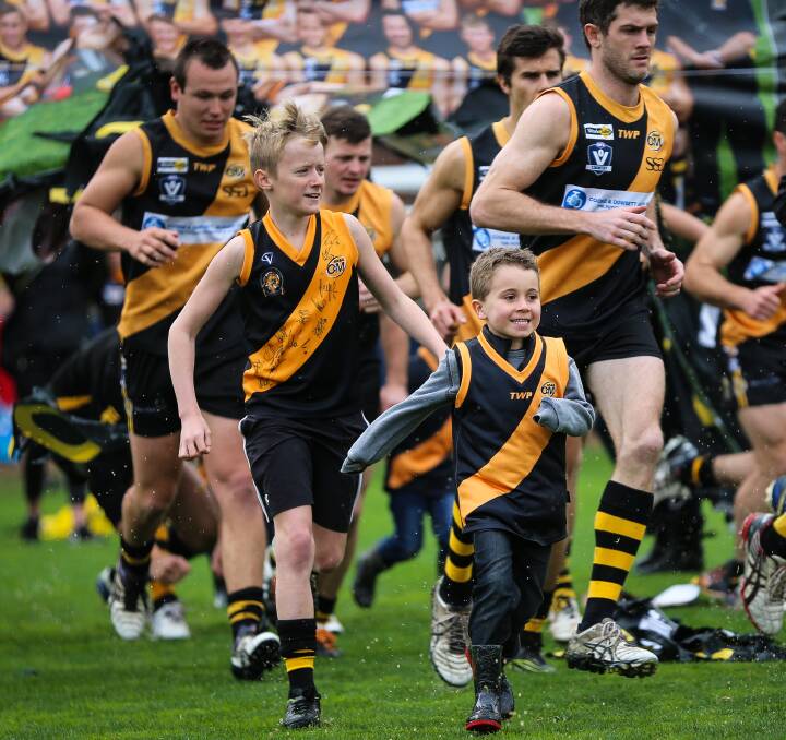 TRUE TIGERS: Young Albury fans Jack Hodgson, 11, and Tyler Cross, 5, soak up the grand final atmosphere as they run out with the Tigers. Picture: JAMES WILTSHIRE