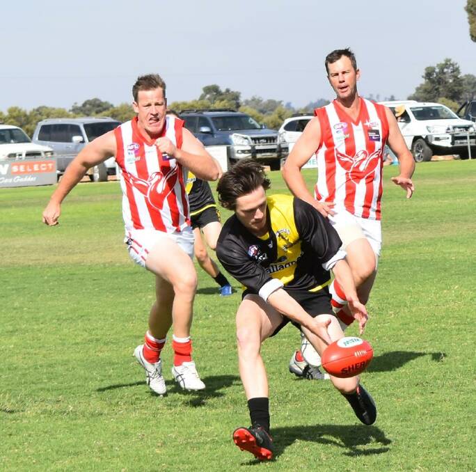 CHASING TIGERS: Henty's Josh Gaynor and Chris Willis chase down Osborne's Connor Galvin during the John Jacobsen  Memorial Match at the weekend. Picture: Lorri Roden