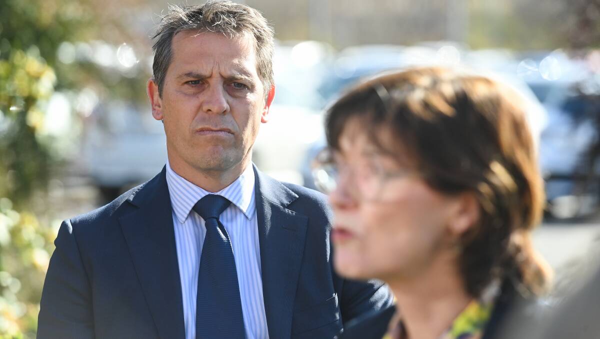 Ryan Park watches his Victorian counterpart Mary-Anne Thomas at a media conference in Albury in September. At the time a briefing had been compiled to inform him of the hospital upgrade budget blowout. Picture by Mark Jesser