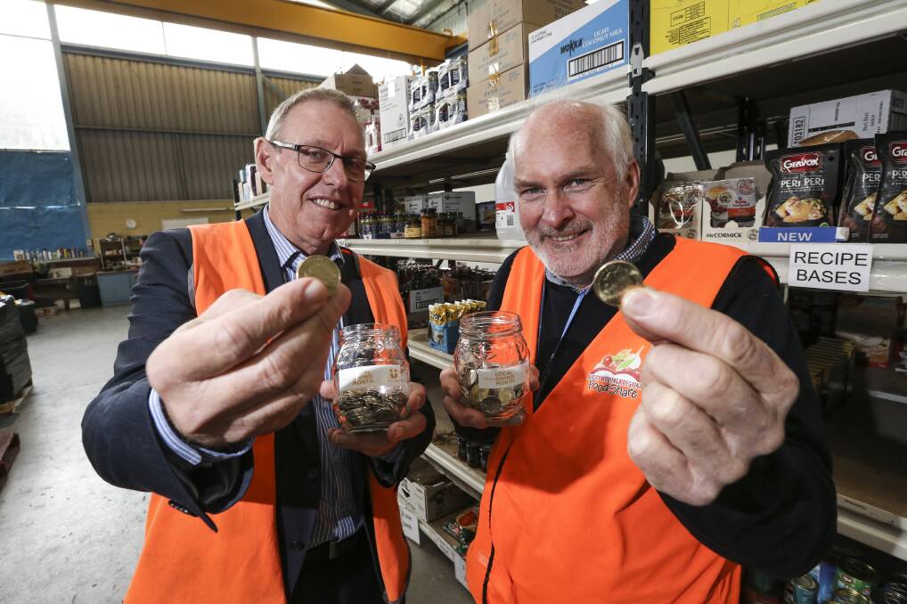 Got a spare coin: Border Trust chairman Michael Salter and FoodShare manager Peter Matthews with $1 pieces which are being sought to help those in need. Picture: JAMES WILTSHIRE