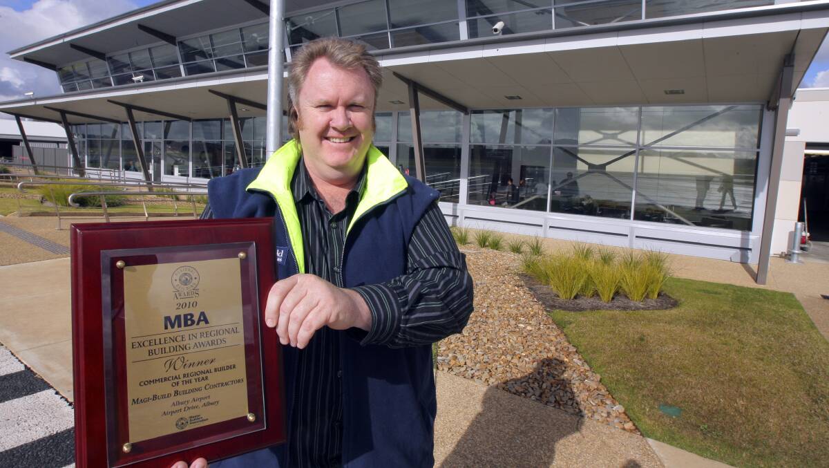 Flashback: Paul Maginnity pictured in 2010 with an award Magi-Build received for its work on the Albury airport terminal.