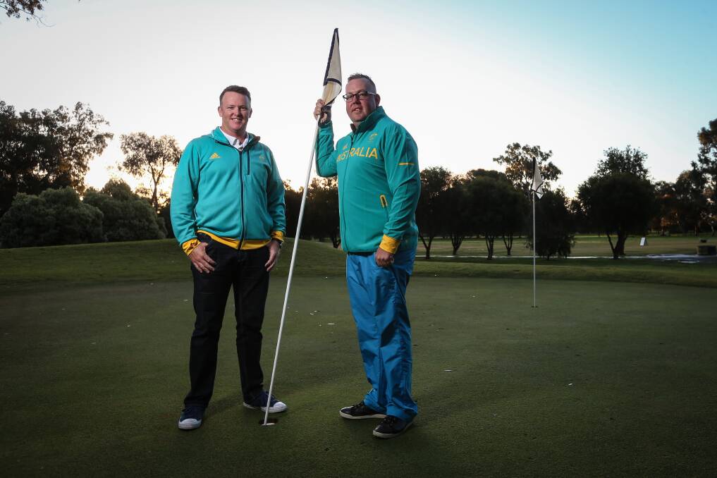 Town's terrific twosome: Marcus Fraser and his caddy Jason Wallis on the practice putting green at Corowa Golf Club after playing against Canberra's Gold Creek Country Club on Saturday. Picture: JAMES WILTSHIRE