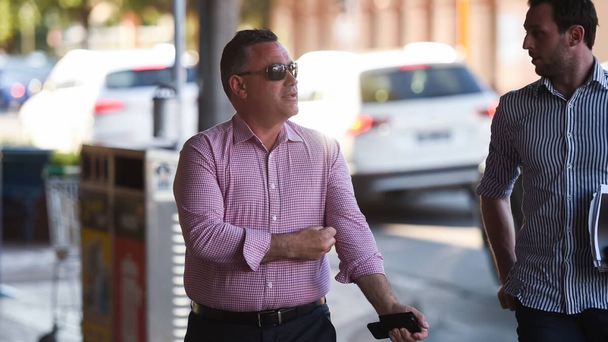 What's going on: NSW Nationals leader John Barilaro looks across at the protest as he prepares to enter Public House. Picture: MARK JESSER