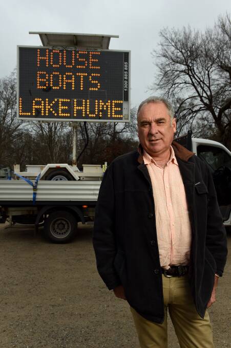 Following through: Murray King at the time of his election campaign when he used a flashing sign to highlight his promise to put houseboats on Lake Hume