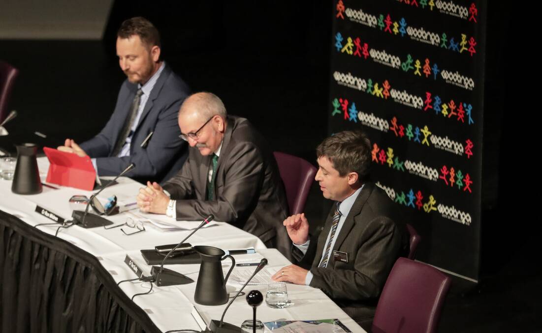 Making his point: Wodonga councillor Tim Quilty addresses the meeting at The Cube to enter a partnership with Albury. His colleagues Danny Lowe and Ron Mildren listen. Picture: JAMES WILTSHIRE