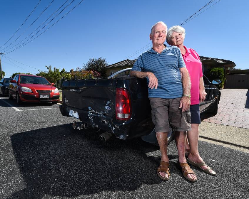 Driven to distraction: Les and Bernice Virtue in front of their Vermont Street home in Wodonga with the damage done to the rear of their ute while reversing from the driveway. Picture: MARK JESSER