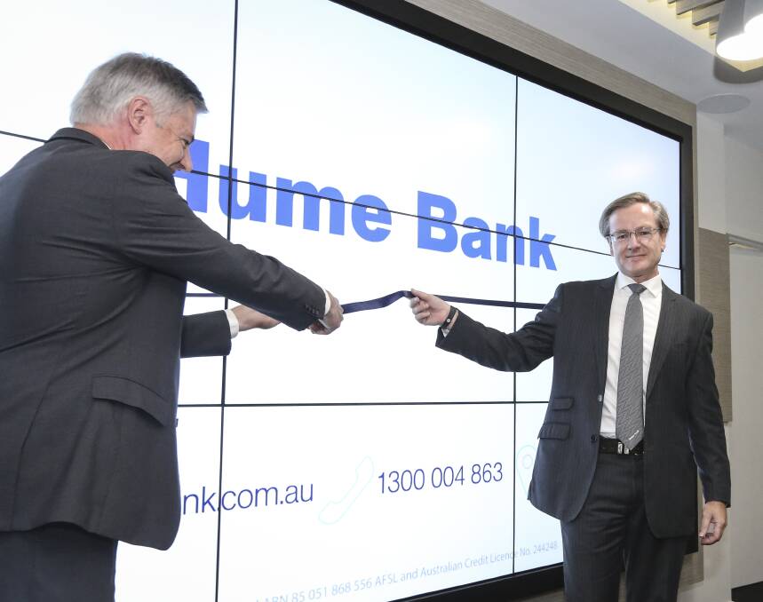 Interest builder: Member for Albury Greg Aplin cuts a ribbon to mark the $1 million renovation of Hume Bank's Olive Street branch as the organisation's chief executive David Marshall looks on. Picture: JAMES WILTSHIRE 