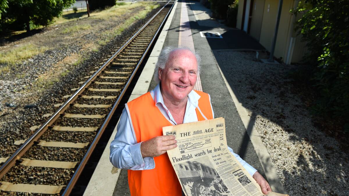 Front page news: Bruce Cumming with his copy of The Age the day after the Southern Aurora train disaster at Violet Town on February 7, 1969. Picture: MARK JESSER