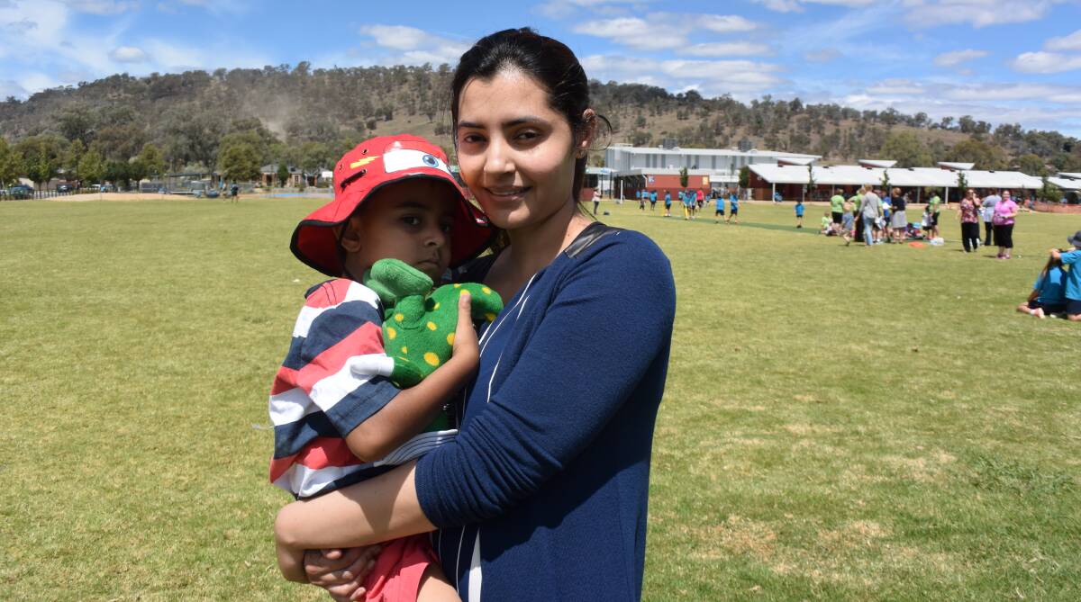 Comforting hug: Tooba Fazal takes her son Uzair, 4, from Southern Rise in Wodonga after the bomb scare saw preschoolers and students evacuated.