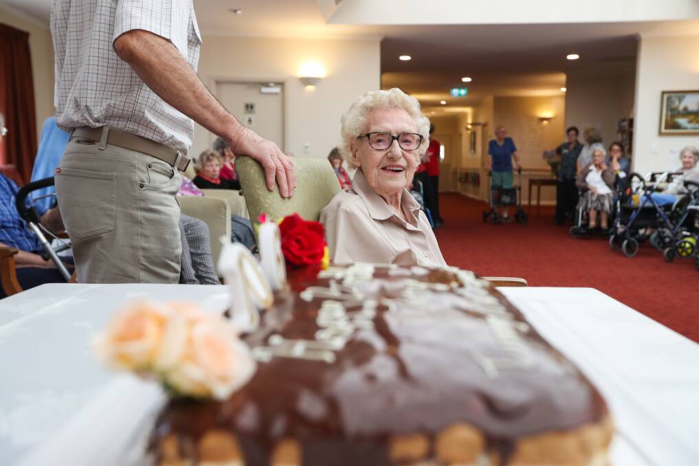 Admiring eye: Ivy Martin takes in the cake made for her 106th birthday  which she celebrated with family and friends. Picture: MARK JESSER
